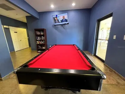 a billiard room with a red pool table at 3BR Cozy Apartment at Caribe Cove Resort Near Disney! in Kissimmee