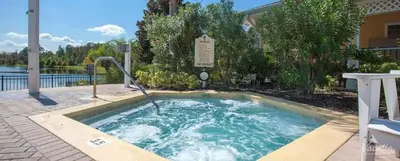 a hot tub in the middle of a yard at 3BR Cozy Apartment at Caribe Cove Resort Near Disney! in Kissimmee