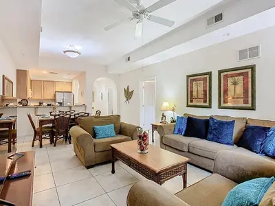a living room with two couches and a table at 3BR Cozy Apartment at Caribe Cove Resort Near Disney! in Kissimmee