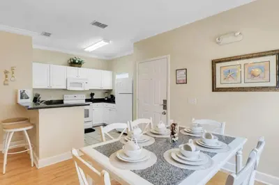a kitchen and dining room with a table and chairs at Cozy 4BR Disney vacation Home7-104 in Kissimmee