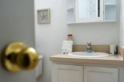a bathroom with a sink and a mirror at Cozy 3BDR House near Disney - AL in Orlando