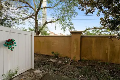 a fence in front of a white fence at Cozy 3BDR House near Disney - AL in Orlando