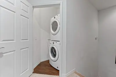 a white laundry room with a washer and dryer at amazing 4bdr house near Disney in Kissimmee