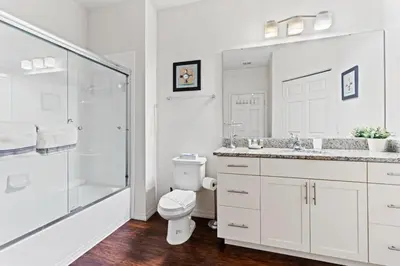 a white bathroom with a toilet and a shower at amazing 4bdr house near Disney in Kissimmee