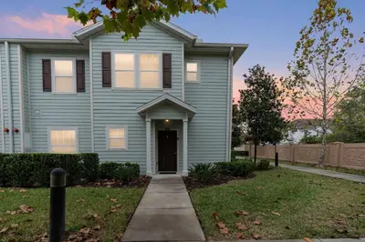 a blue house with a sidewalk in front of it at amazing 4bdr house near Disney in Kissimmee