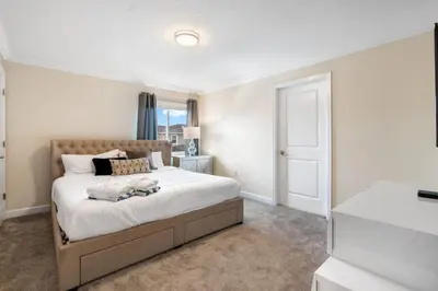 a bedroom with a large bed and a window at Outstanding 5BDR Disney Vacation in Kissimmee