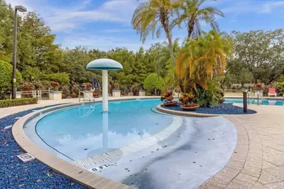 a pool at a resort with palm trees at Home Away from Home in Disney 4106 in Kissimmee