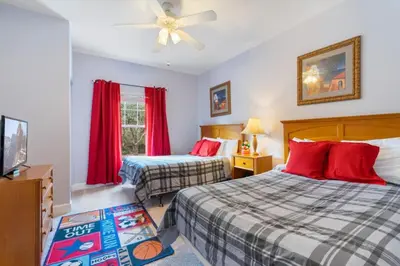 a bedroom with two beds and a ceiling fan at Home Away from Home in Disney 4106 in Kissimmee