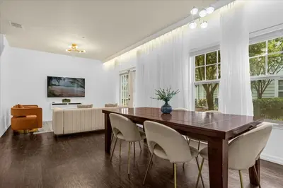 a dining room with a wooden table and chairs at Luxury 4 BDR House near Disney 11105 in Kissimmee