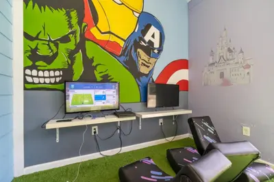 a room with a desk with a computer and a mural at Luxury 4 BDR House near Disney 11105 in Kissimmee