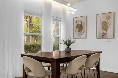 a dining room with a wooden table and chairs at Luxury 4 BDR House near Disney 11105 in Kissimmee
