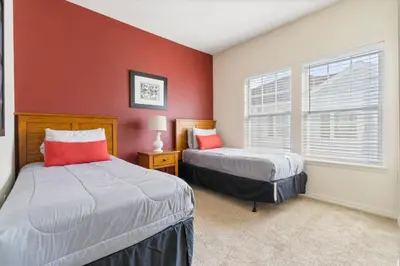 two beds in a room with red walls at Amazing 4bdr house in Disney 20104 in Kissimmee