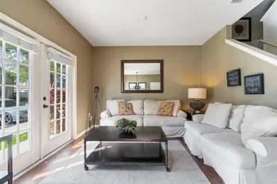 a living room with a white couch and a table at Amazing 4bdr house in Disney 20104 in Kissimmee