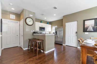 a kitchen with a counter and a clock on the wall at Amazing 4bdr house in Disney 20104 in Kissimmee