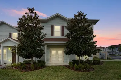a house with two trees in the front yard at Amazing 4BDR few miles from Disney in Kissimmee