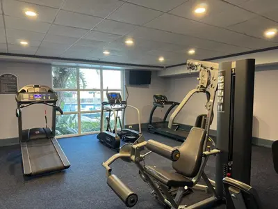 a gym with two tread machines and a treadmill at Beautiful Orlando Lakefront Condo 5 MINUTES FROM DISNEY in Orlando