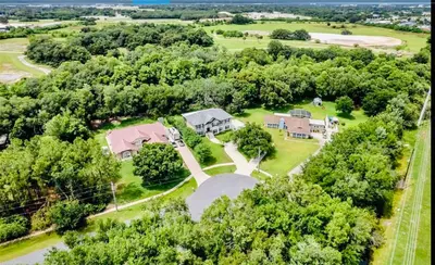 an aerial view of a home with a yard and trees at Amazing Waterfront Apt near Disney and Lake Tohoa in Kissimmee