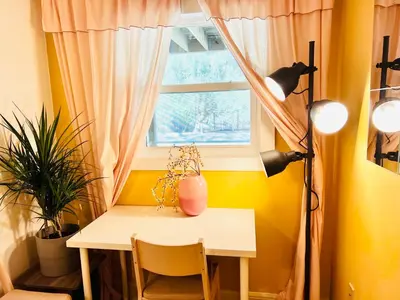 a desk in a room with a window and a table at Amazing Waterfront Apt near Disney and Lake Tohoa in Kissimmee