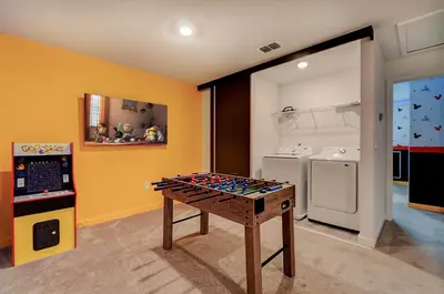 a room with a game table in the middle of a kitchen at 3417 Brand New 3BD Family Home Near Disney in Kissimmee