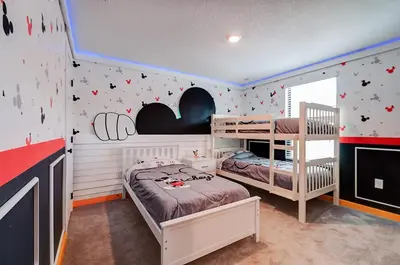 a bedroom with two bunk beds and a wall with stars at 3417 Brand New 3BD Family Home Near Disney in Kissimmee