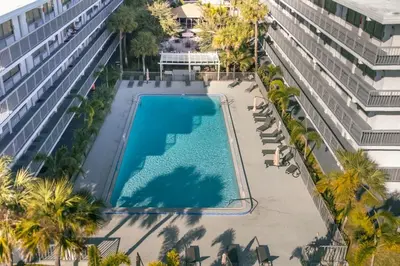 an overhead view of a swimming pool next to a building at Luxury Studio Gem 10min to Disney Pool and Amenities in Kissimmee