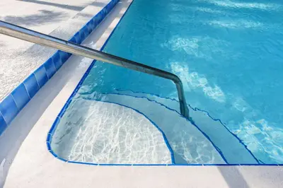 a swimming pool with a ramp in the water at Luxury Studio Gem 10min to Disney Pool and Amenities in Kissimmee