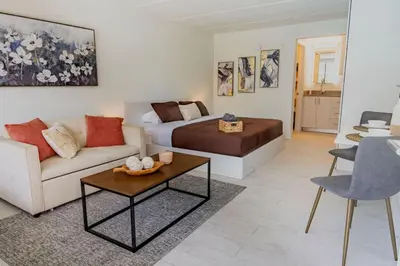 a living room with a bed and a couch at Luxury and Cozy Gem 15min to Disney Free Parking in Kissimmee