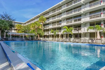 a large swimming pool in front of a building at Modern New APT in perfect Location only 10min to Disney in Kissimmee