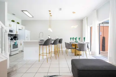 a kitchen and dining room with a table and chairs at Gorgeous 4Bd w Pool at Encantada Resort 8523 in Kissimmee