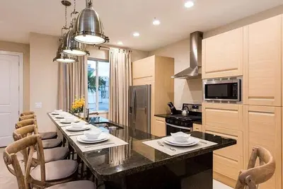 a kitchen with a long table with chairs around it at Super Close to Disney Magic Stays in Orlando