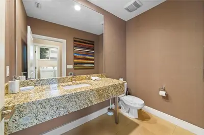 a bathroom with a sink and a toilet at Super Close to Disney Magic Stays in Orlando