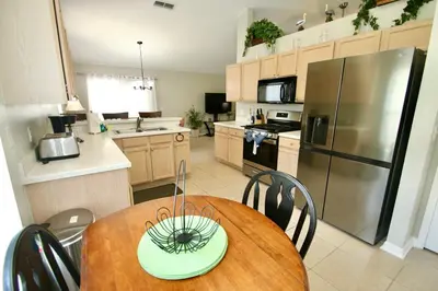 a kitchen with a table with a green bowl on it at Family Escape Close to parks in Orlando