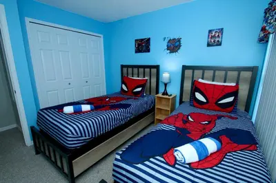 a bedroom with two beds with superheroes on them at Family Escape Close to parks in Orlando