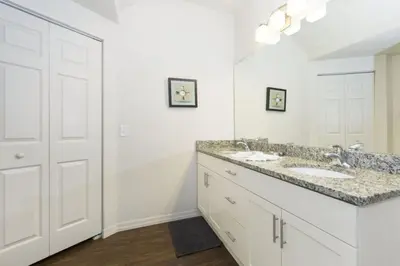 a bathroom with two sinks and a large mirror at Amazing 3Bdr House near Disney 16106 in Kissimmee