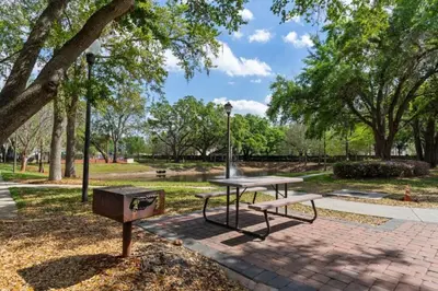 a picnic table and a grill in a park at Amazing 3Bdr House near Disney 16106 in Kissimmee