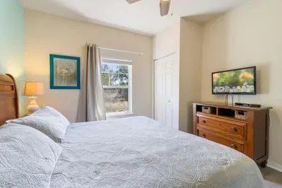 a bedroom with a bed and a dresser and a window at Amazing 3BDR House near Disney 12102 in Kissimmee