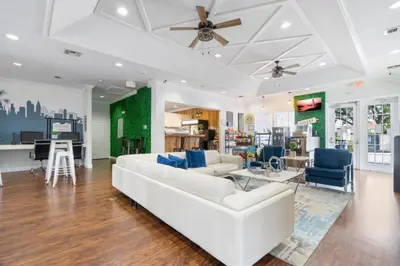 a living room with a white couch and blue chairs at Amazing 3BDR House near Disney 12102 in Kissimmee