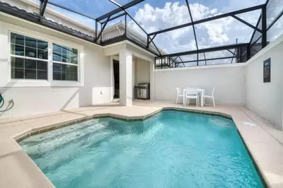 a swimming pool in a house with a glass ceiling at Casa 5 Quartos c/ Piscina Privativa no Storey Lake in Kissimmee