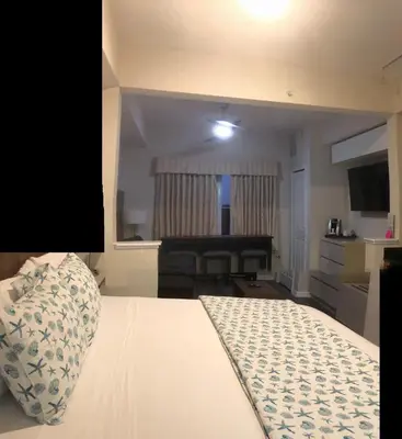 a hotel room with a bed and a bedroom with a piano at Universal-Disney Dream 606H Studio - The Point in Orlando