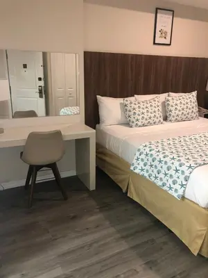 a bedroom with a bed and a desk and a mirror at Universal-Disney Dream 606H Studio - The Point in Orlando