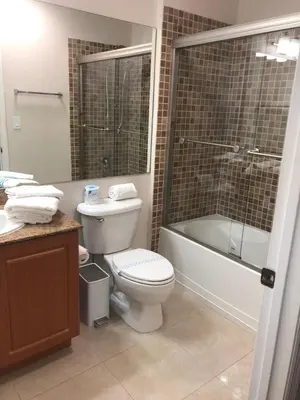 a bathroom with a toilet and a shower and a sink at Universal-Disney Dream 606H Studio - The Point in Orlando