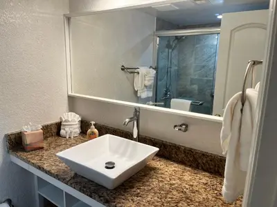a bathroom with a sink and a large mirror at Universal-Disney Dream 3413 Studio - The Enclave in Orlando