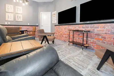 a living room with a couch and a brick fireplace at 10251 EBB Tide Lane in Orlando