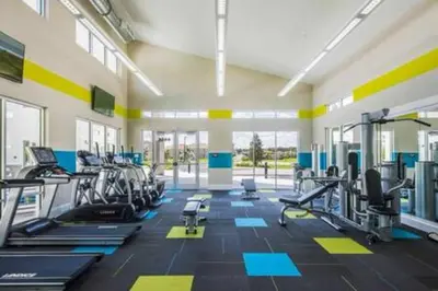 a gym with several treadmills and cardio machines at 4 Bedroom with Pool near to Disney in Kissimmee