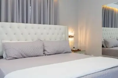 a bedroom with a large bed with a white headboard at 4 Bedroom with Pool near to Disney in Kissimmee
