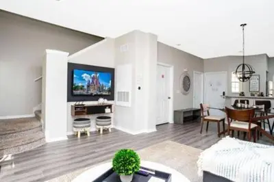a living room with a couch and a dining room at Emerald Island Resort townhouse 3 Bedrooms in Kissimmee