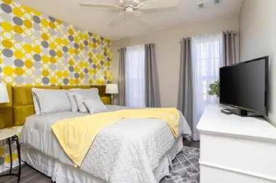 a bedroom with a bed and a flat screen tv at Emerald Island Resort townhouse 3 Bedrooms in Kissimmee