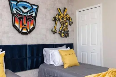 a bedroom with a bed with a mask on the wall at Emerald Island Resort townhouse 3 Bedrooms in Kissimmee