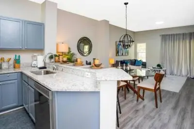 a kitchen with a table and a dining room at Emerald Island Resort townhouse 3 Bedrooms in Kissimmee