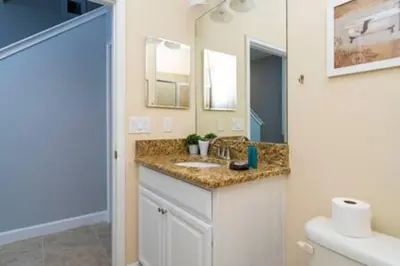 a bathroom with a sink and a mirror at 4 Bedrooms3 Bathrooms at Storey Lake Resort in Kissimmee